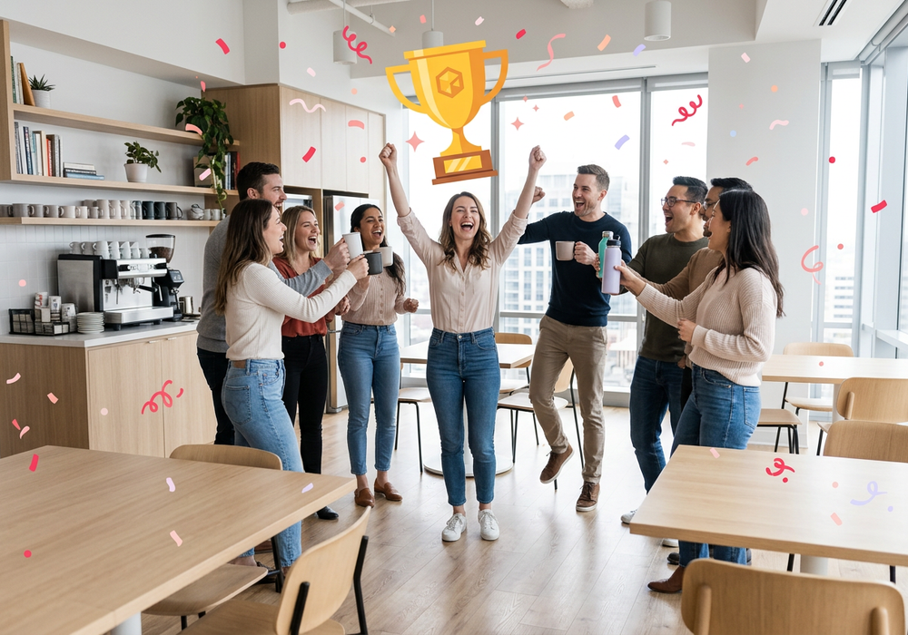 A team celebrating a colleague in the office kitchen with an illustrated trophy overhead