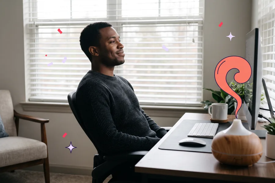 Man leaning back at his home desk beside an essential oil diffuser