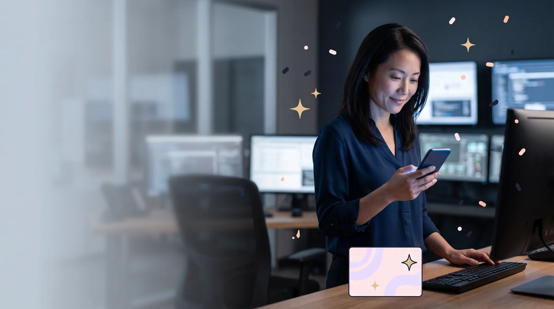 Security analyst in an operations room smiling at a gift link on her phone