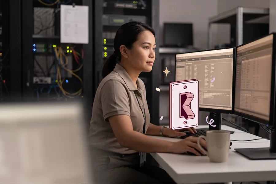 IT specialist reviewing a directory sync on two monitors